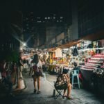 a woman sitting in a chair in a market